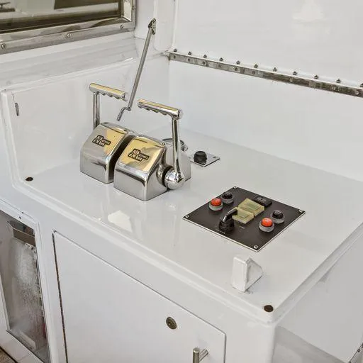 Slide: The Image of Control panel of a 1991 Vic Franck 65 Motor Yacht with throttle levers and buttons. - 15