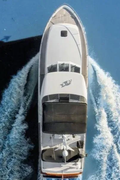 Slide: The Image of Overhead view of a 1991 Vic Franck 65 Motor Yacht cruising on water. - 2