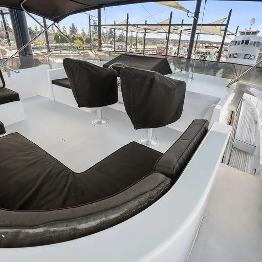 Slide: The Image of 1991 Vic Franck 65 Motor Yacht deck with black seating and covered chairs. - 22