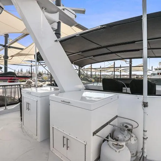 Slide: The Image of 1991 Vic Franck 65 Motor Yacht deck with storage cabinets and propane tank. - 24