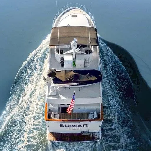 Slide: The Image of Aerial view of 1991 Vic Franck 65 Motor Yacht cruising on calm water. - 3