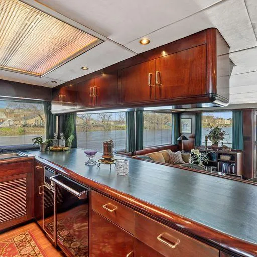 Slide: The Image of Luxurious interior of 1991 Vic Franck 65 Motor Yacht with elegant wood cabinetry and scenic views. - 31