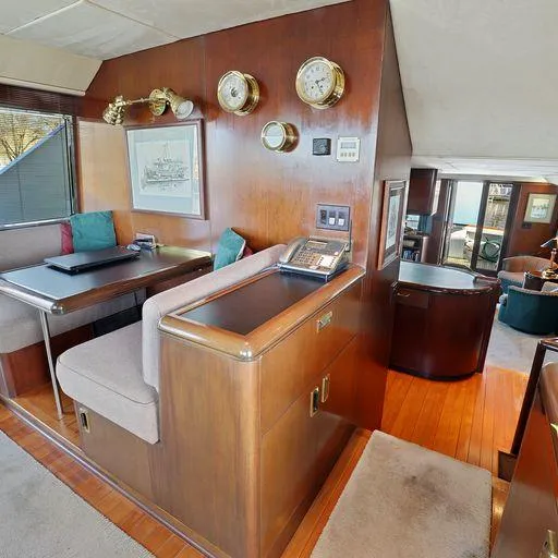 Slide: The Image of Luxurious interior of a 1991 Vic Franck 65 Motor Yacht with wood paneling and seating area. - 34