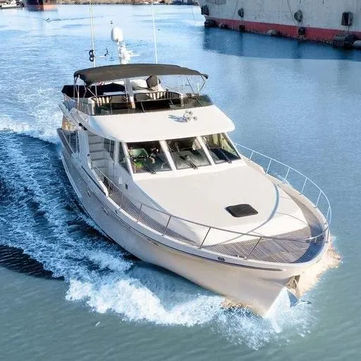 Slide: The Image of 1991 Vic Franck 65 Motor Yacht cruising on calm waters. - 4