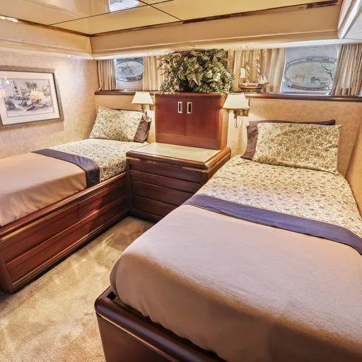 Slide: The Image of Luxurious twin bedroom in a 1991 Vic Franck 65 Motor Yacht, featuring elegant wood finishes. - 45
