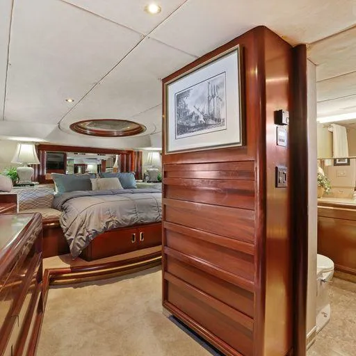 Slide: The Image of Luxurious 1991 Vic Franck 65 Motor Yacht bedroom with elegant wood paneling and cozy bedding. - 47