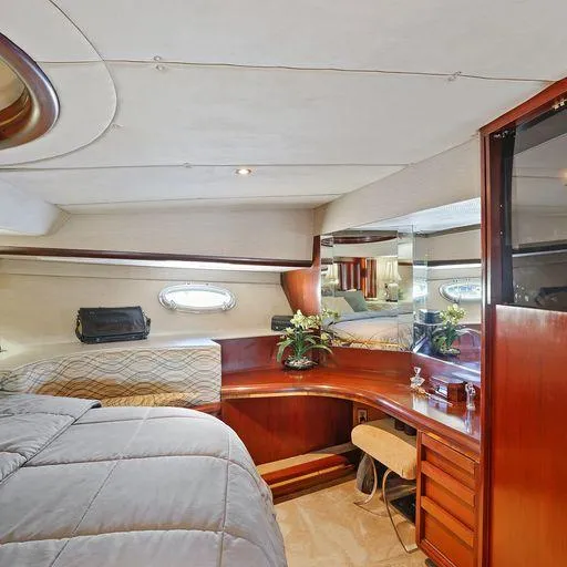 Slide: The Image of Luxurious interior of 1991 Vic Franck 65 Motor Yacht with elegant wood finishes and cozy bedding. - 48