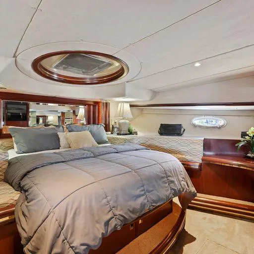 Slide: The Image of Luxurious bedroom interior of a 1991 Vic Franck 65 Motor Yacht, featuring elegant wood finishes. - 49