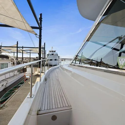 Slide: The Image of 1991 Vic Franck 65 Motor Yacht docked, showcasing sleek design and polished deck. - 8