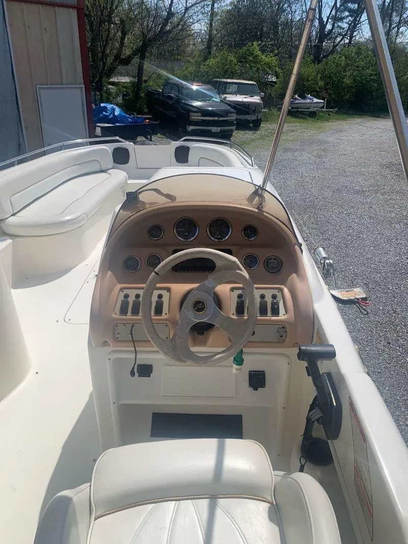 Slide: The Image of 1998 Sea Ray 240 Sundeck boat interior with steering wheel and control panel. - 10