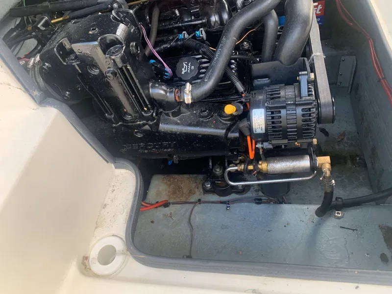 Slide: The Image of Engine compartment of a 1998 Sea Ray 240 Sundeck boat, showing detailed mechanical components. - 15