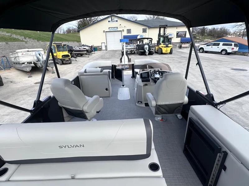 Slide: The Image of 2025 Sylvan Mirage X X5 CLZ DH pontoon boat interior at a marina. - 10