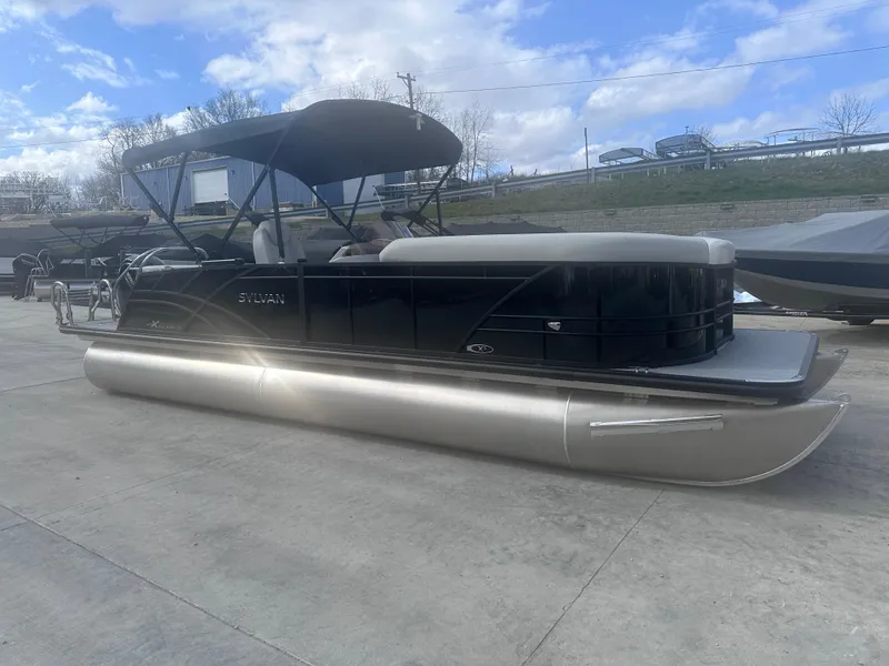 Slide: The Image of 2025 Sylvan Mirage X X5 CLZ DH pontoon boat on concrete surface under blue sky. - 4