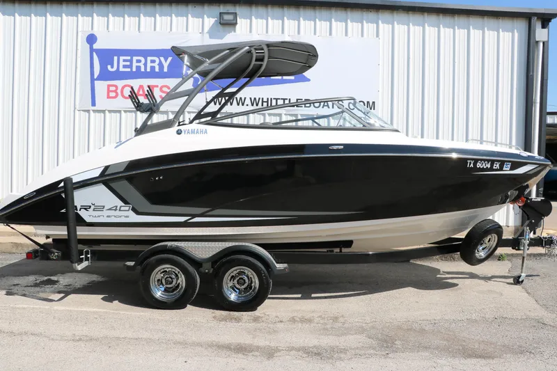 Slide: The Image of 2018 Yamaha AR240 HO boat on trailer, displayed outside dealership. - 13