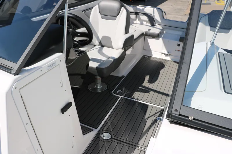 Slide: The Image of 2018 Yamaha Boats AR240 HO interior with steering wheel and seating area. - 24
