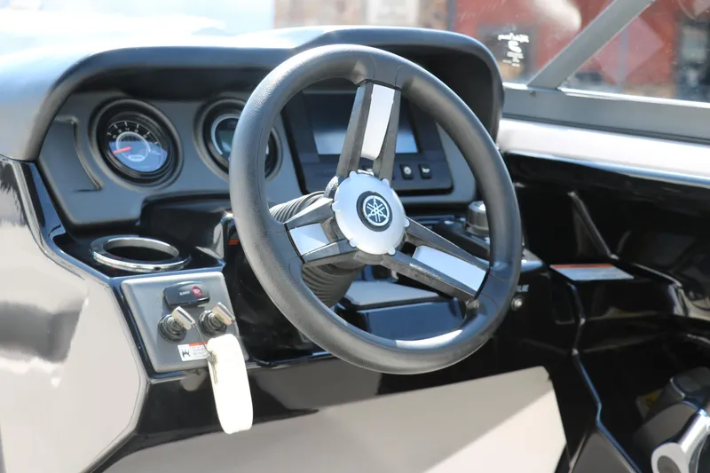 Slide: The Image of 2018 Yamaha AR240 HO boat dashboard with steering wheel and gauges. - 26