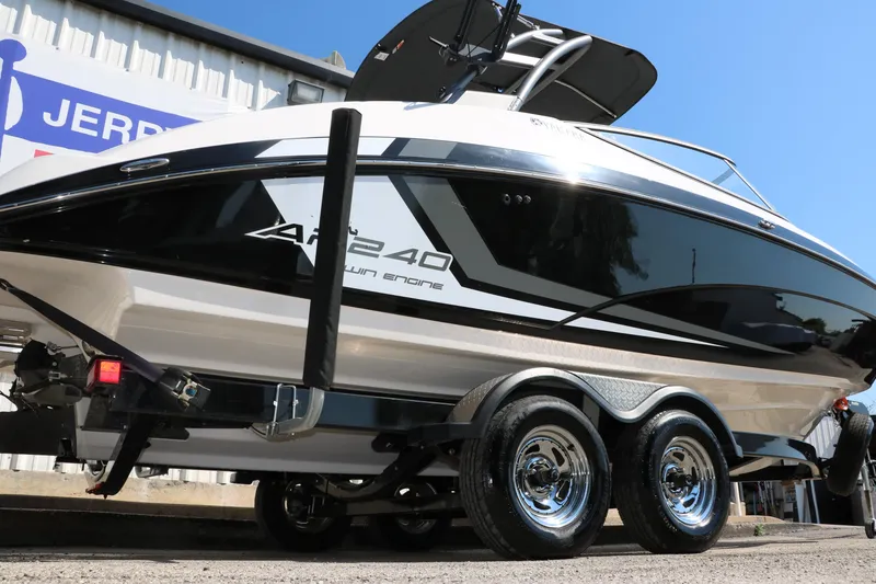 Slide: The Image of 2018 Yamaha Boats AR240 HO on trailer, sleek black and white design, dual axle. - 3
