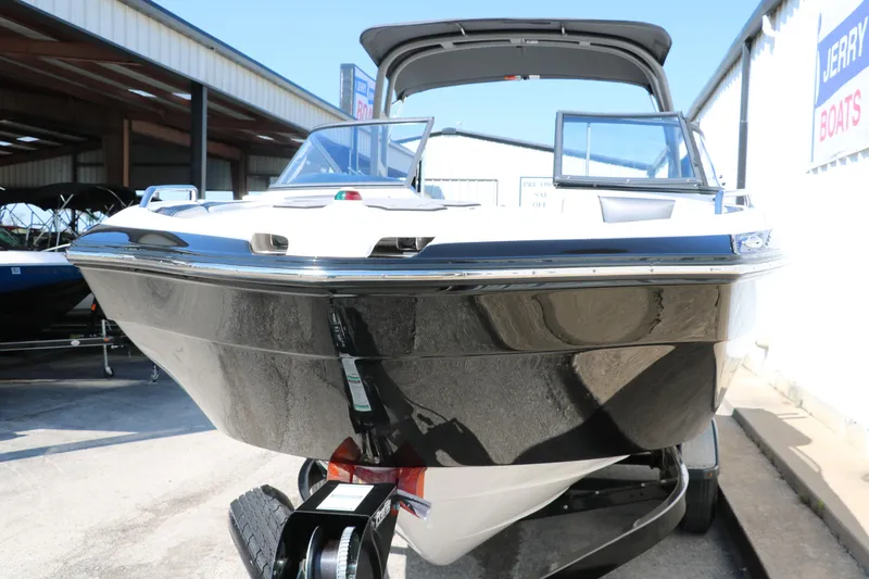 Slide: The Image of 2018 Yamaha Boats AR240 HO, sleek design, black and white exterior, on trailer, outdoor display. - 8