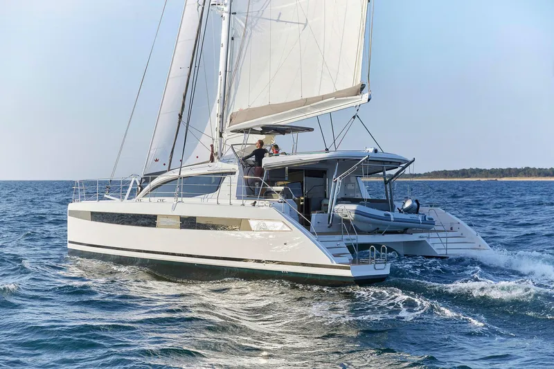 Slide: The Image of Luxury Privilege Signature 510 catamaran sailing on open water, 2025 model. - 2