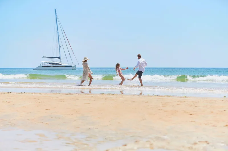 Slide: The Image of Family enjoying beach with Privilege Signature 510 yacht in background, 2025. - 23