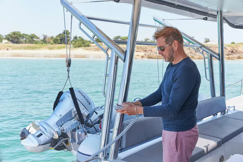 Slide: The Image of Man on Privilege Signature 510 yacht operating equipment, 2025 model, near scenic shoreline. - 24