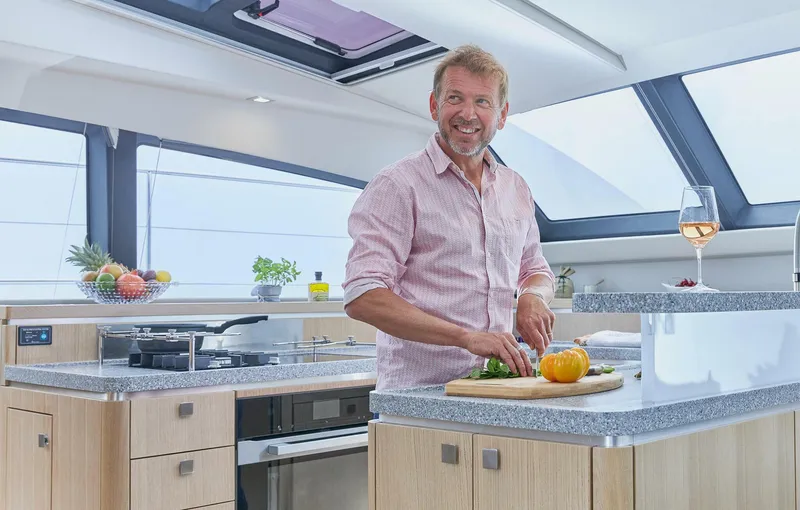 Slide: The Image of Man cooking in modern kitchen aboard 2025 Privilege Signature 510 yacht. - 33