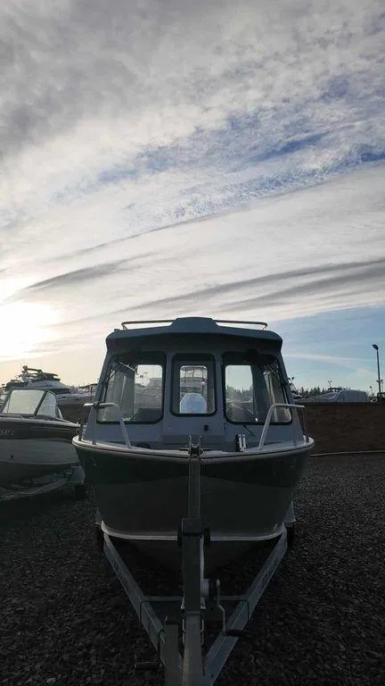 Slide: The Image of 2018 Hewescraft 210 Sea Runner boat on trailer under cloudy sky. - 3