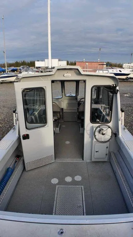 Slide: The Image of 2018 Hewescraft 210 Sea Runner boat interior, featuring spacious cabin and steering wheel. - 6