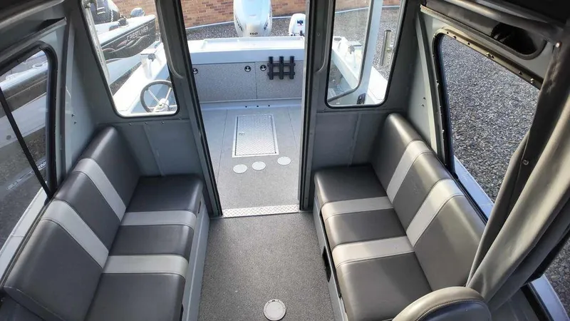 Slide: The Image of 2018 Hewescraft 210 Sea Runner interior with gray seating and spacious cabin layout. - 9