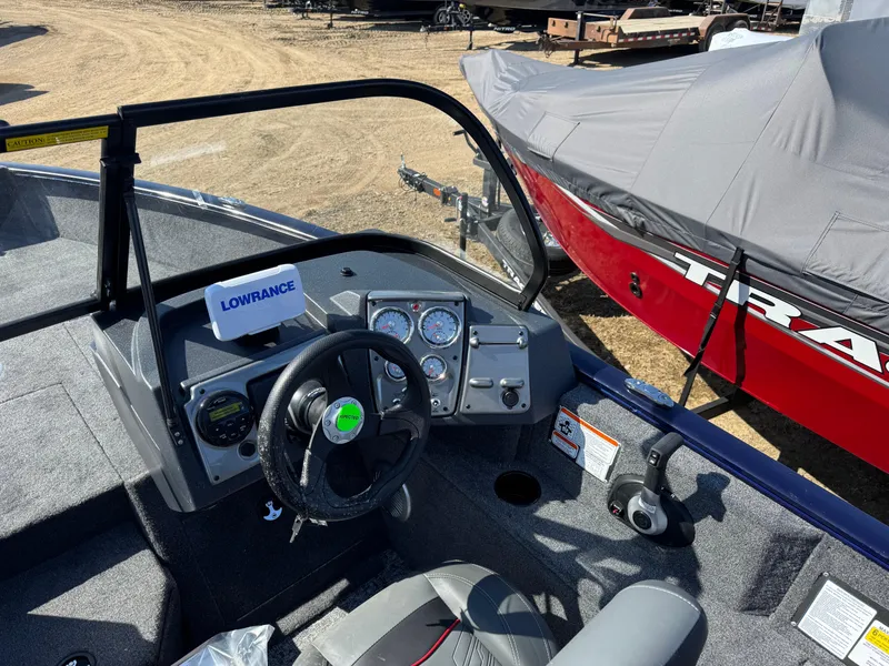 Slide: The Image of 2025 Tracker Pro Guide V-175 WT boat interior with steering wheel and Lowrance electronics. - 13