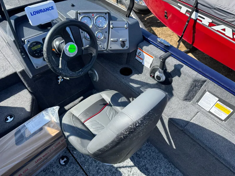 Slide: The Image of 2025 Tracker Pro Guide V-175 WT boat interior with steering wheel and control panel. - 14