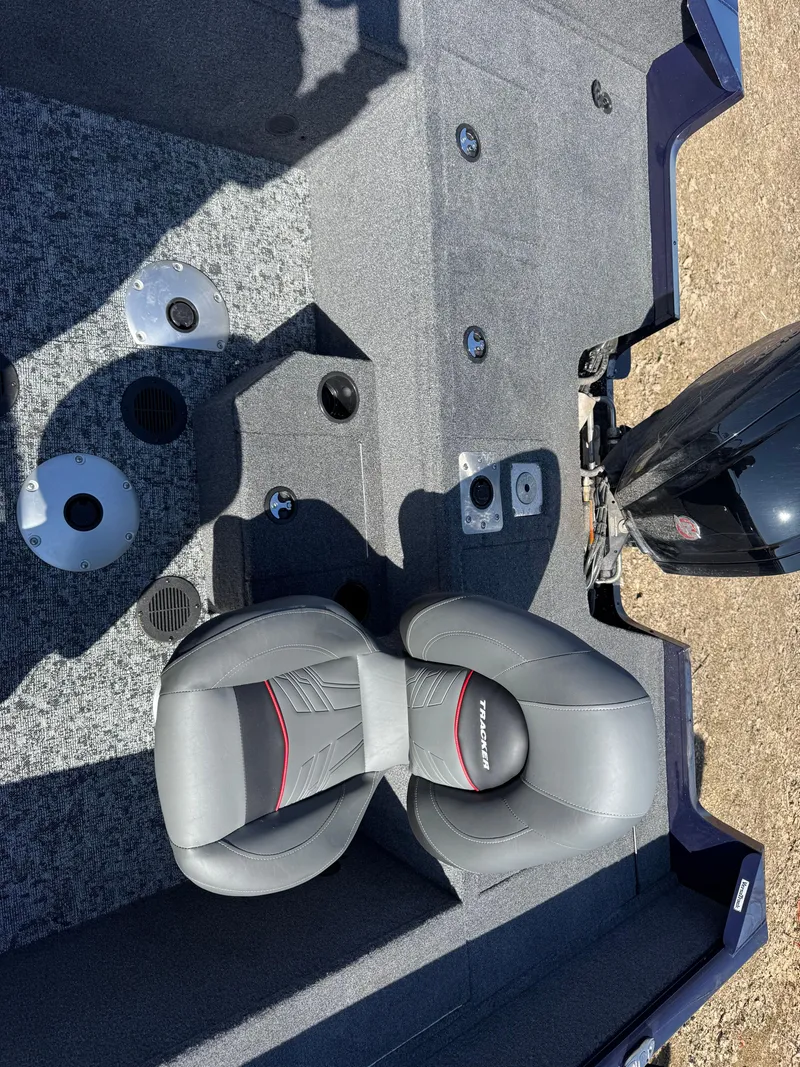 Slide: The Image of 2025 Tracker Pro Guide V-175 WT boat interior with seating and motor. - 17