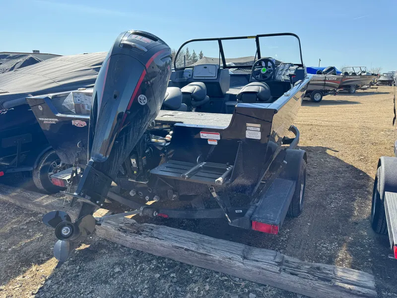 Slide: The Image of 2025 Tracker Pro Guide V-175 WT boat with outboard motor, parked on a trailer. - 2