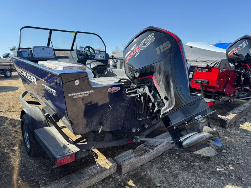 Slide: The Image of 2025 Tracker Pro Guide V-175 WT boat with powerful outboard motor on a trailer. - 3