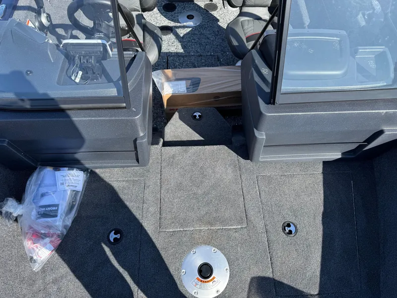 Slide: The Image of 2025 Tracker Pro Guide V-175 WT boat interior with dual consoles and carpeted flooring. - 6