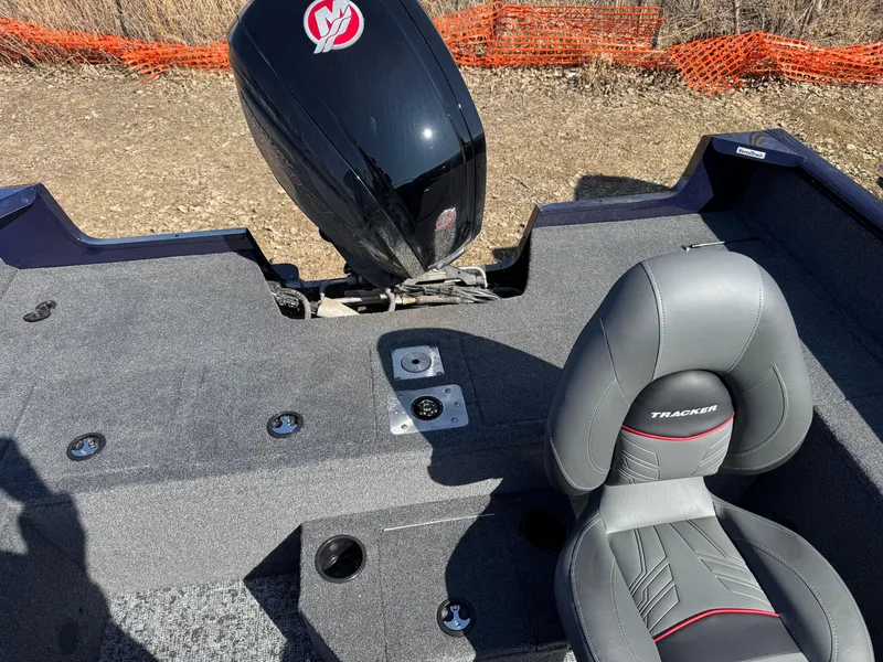 Slide: The Image of 2025 Tracker Pro Guide V-175 WT boat interior with motor and seating. - 9