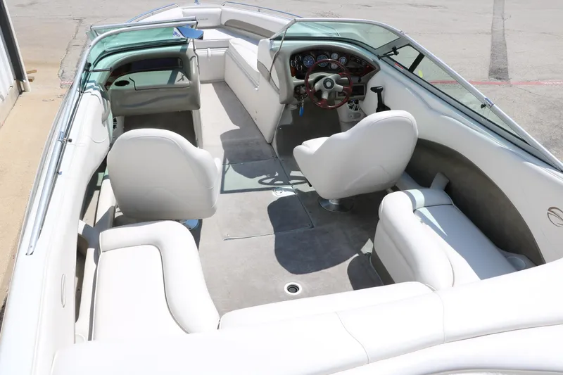 Slide: The Image of 2001 Crownline 225 BR boat interior with white seating and steering console. - 15