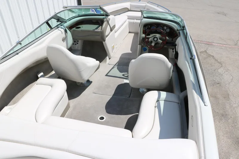 Slide: The Image of 2001 Crownline 225 BR boat interior with white seating and steering console. - 18