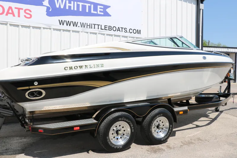 Slide: The Image of 2001 Crownline 225 BR boat on trailer at Whittle Boats dealership. - 2