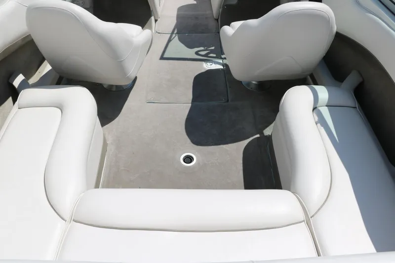 Slide: The Image of 2001 Crownline 225 BR boat interior with white seating and gray flooring. - 20