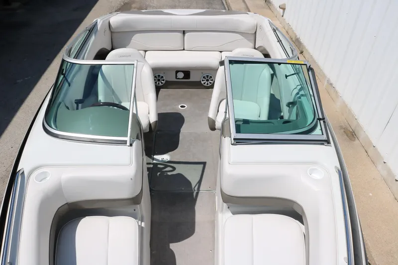 Slide: The Image of 2001 Crownline 225 BR boat interior with white seating and dual windshields. - 22