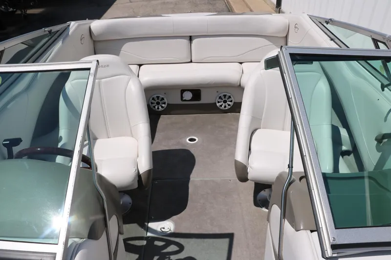 Slide: The Image of 2001 Crownline 225 BR boat interior with white seating and glass windshields. - 24