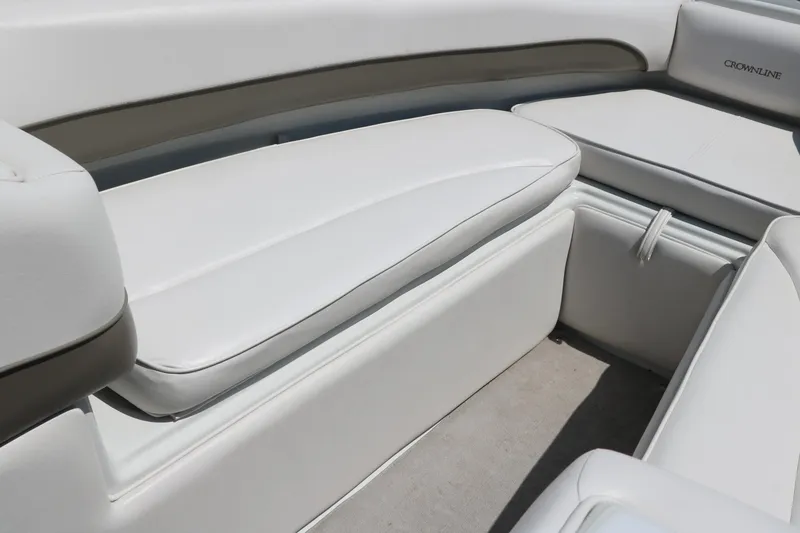 Slide: The Image of 2001 Crownline 225 BR boat interior with white cushioned seating. - 29
