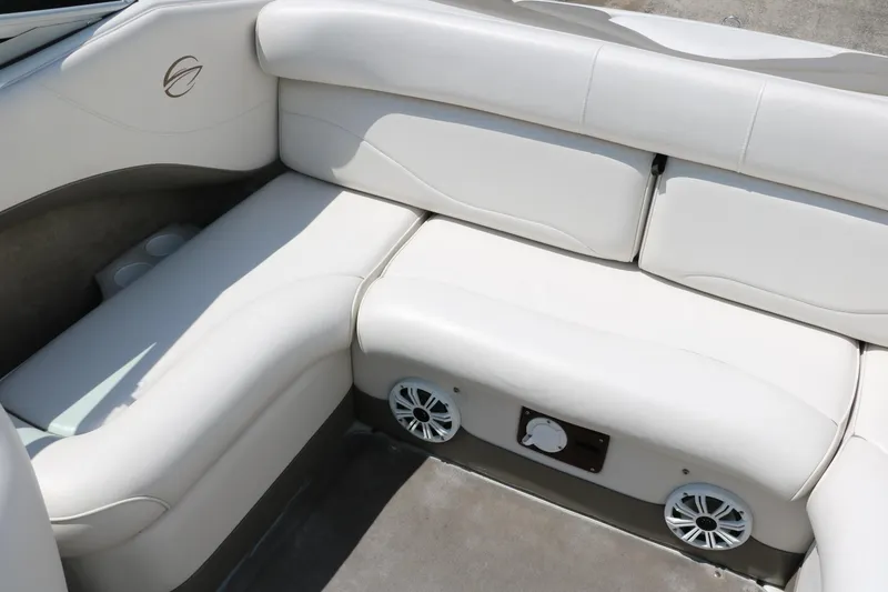 Slide: The Image of 2001 Crownline 225 BR boat interior with white cushioned seating and built-in speakers. - 30