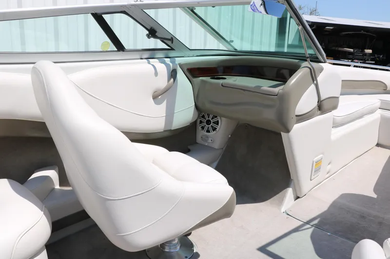 Slide: The Image of Interior of a 2001 Crownline 225 BR boat with white seating and dashboard. - 31