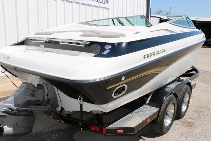 Slide: The Image of 2001 Crownline 225 BR boat on trailer, white and black design, parked outdoors. - 5
