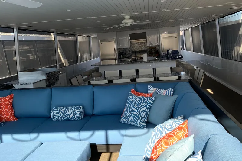 Slide: The Image of Luxurious Adonia Traditions 6 shares 2020 houseboat interior with blue seating and vibrant cushions. - 16