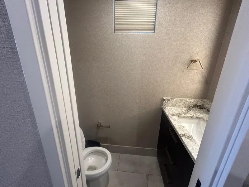 Slide: The Image of Compact bathroom with granite countertop and toilet, Adonia Traditions 6 shares, 2020 model. - 7