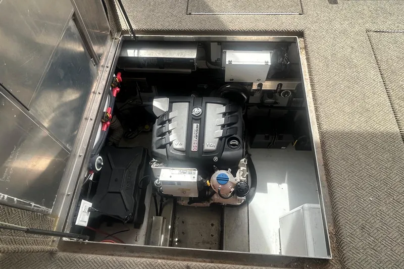 Slide: The Image of Engine compartment of a 2020 Adonia Traditions 6 shares boat, showcasing mechanical components. - 9