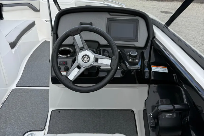 Slide: The Image of 2020 Yamaha SX240 boat dashboard with steering wheel and control panel. - 10